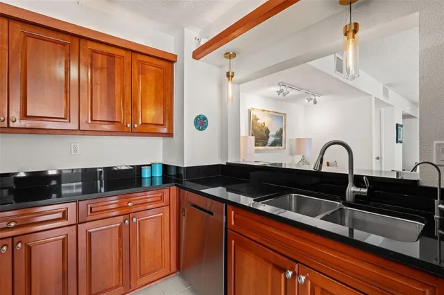 a kitchen with granite countertop a sink and cabinets