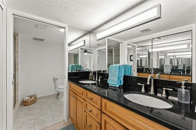 a bathroom with double vanity sinks double vanity shower and a mirror