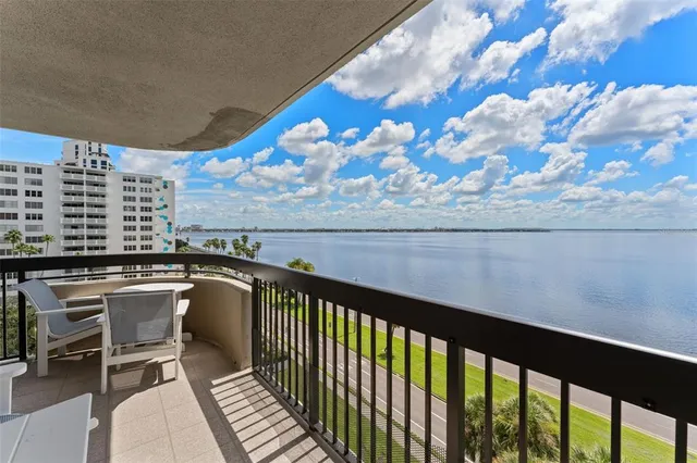 a view of a balcony with chair and table