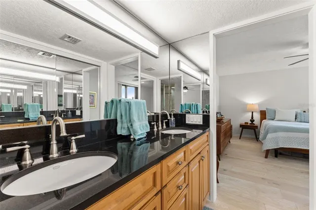 a kitchen with sink and view of living room