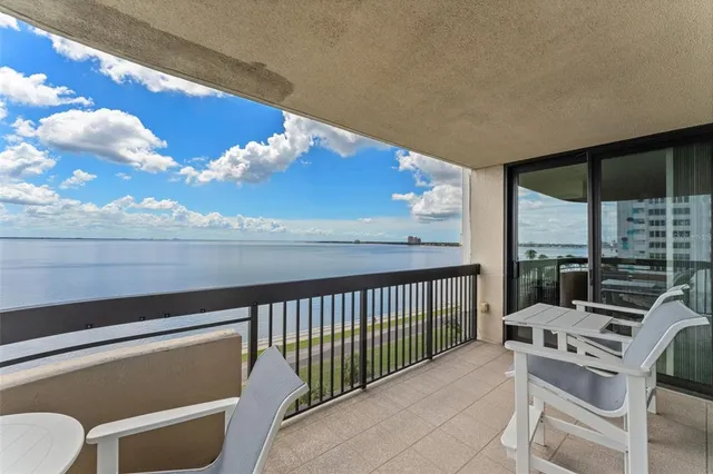 a balcony with a table and chairs