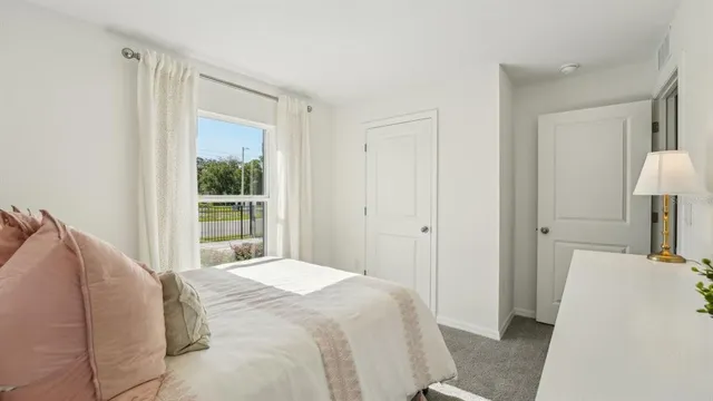 a bedroom with a bed and a mirror