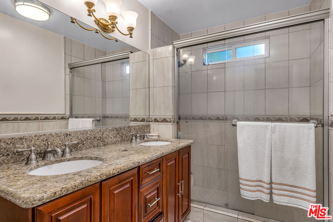 535 Winslow Avenue Long Beach, CA 90814 - Photo 15 of 32 a bathroom with a granite countertop sink and a mirror