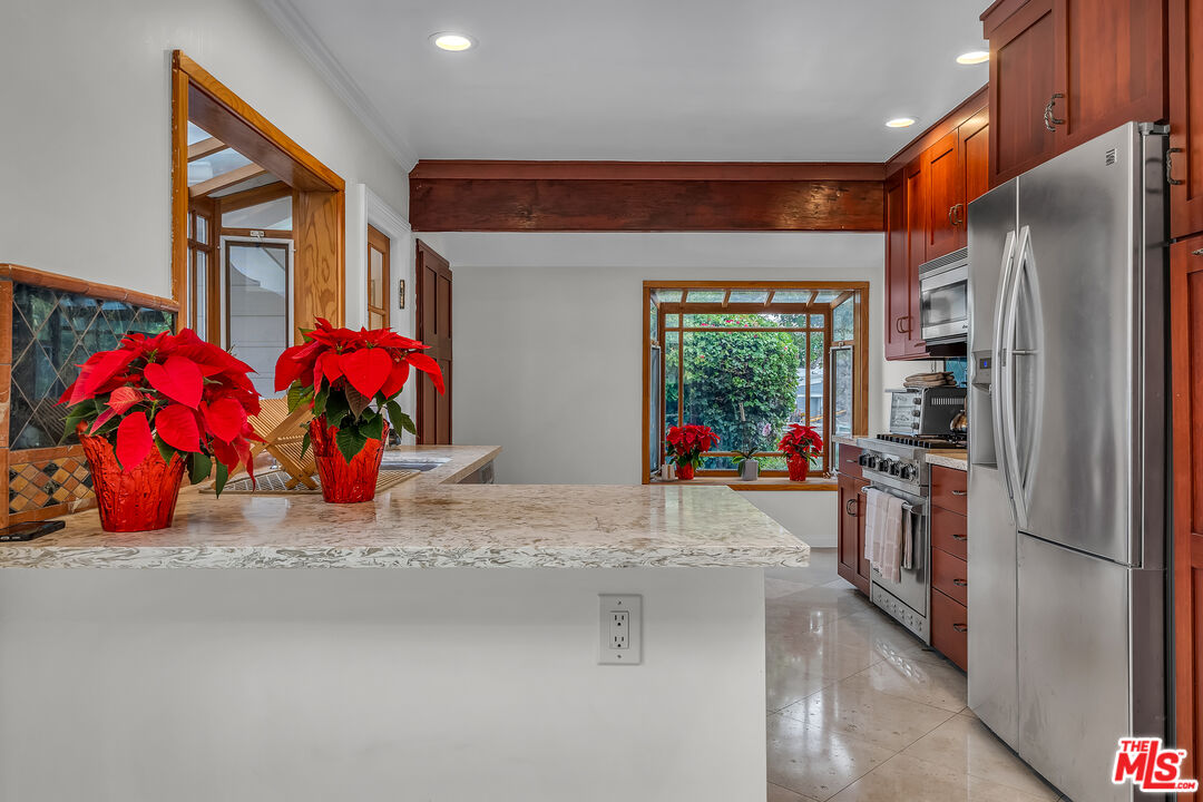 535 Winslow Avenue Long Beach, CA 90814 - Photo 8 of 32 a kitchen with stainless steel appliances granite countertop a refrigerator and a stove