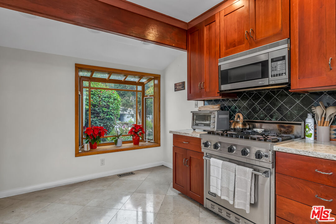 535 Winslow Avenue Long Beach, CA 90814 - Photo 10 of 32 a kitchen with stainless steel appliances granite countertop a stove top oven microwave and cabinets