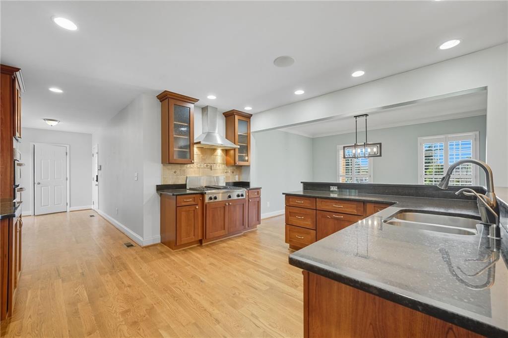2347 Univeter Road Canton, GA 30115 - Photo 13 of 46 a kitchen with stainless steel appliances granite countertop a sink and stove