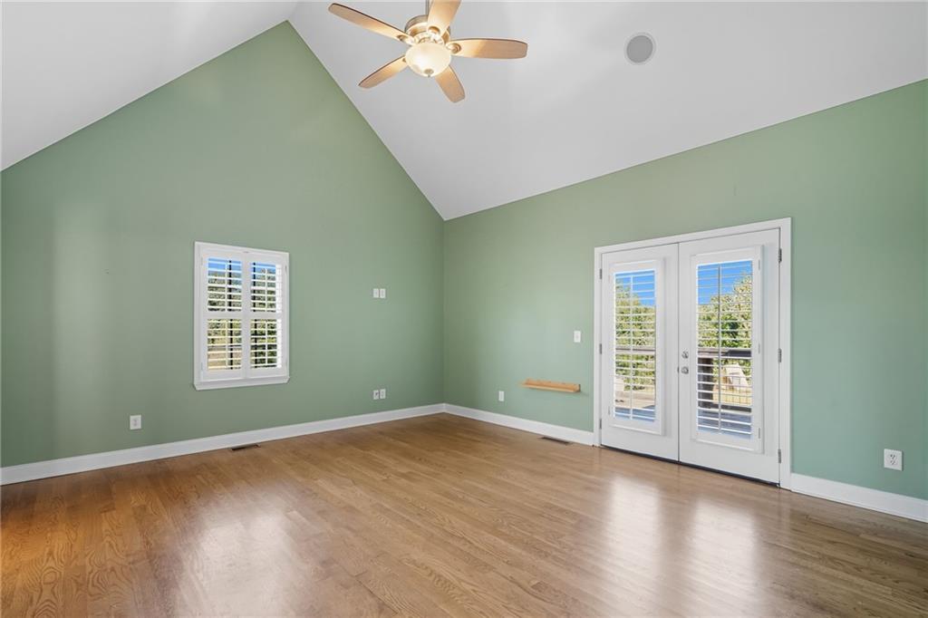 2347 Univeter Road Canton, GA 30115 - Photo 20 of 46 an empty room with wooden floor closet and windows