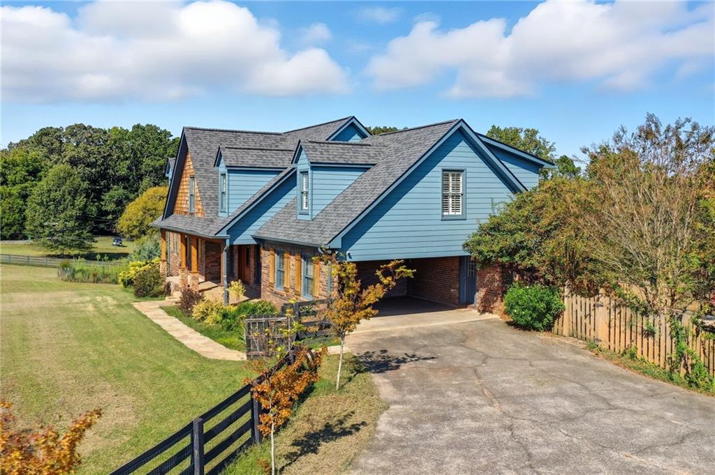2347 Univeter Road Canton, GA 30115 - Photo 2 of 46 a view of a house with wooden fence