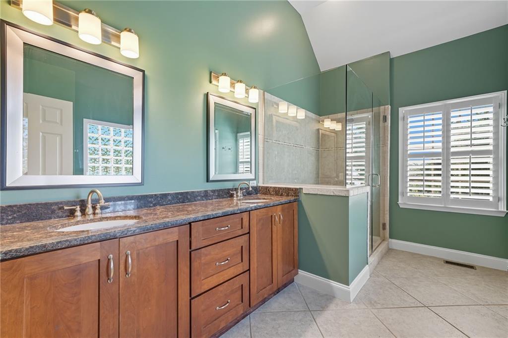 2347 Univeter Road Canton, GA 30115 - Photo 21 of 46 a bathroom with a double vanity sink and a mirror