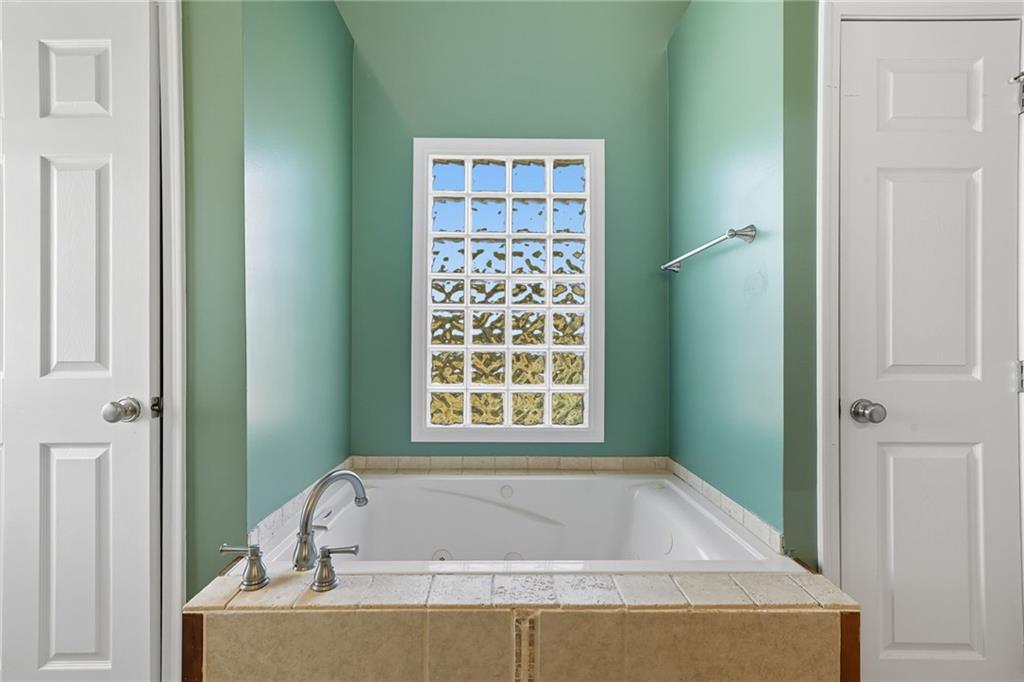 2347 Univeter Road Canton, GA 30115 - Photo 22 of 46 a bath tub sitting in a bathroom next to a window
