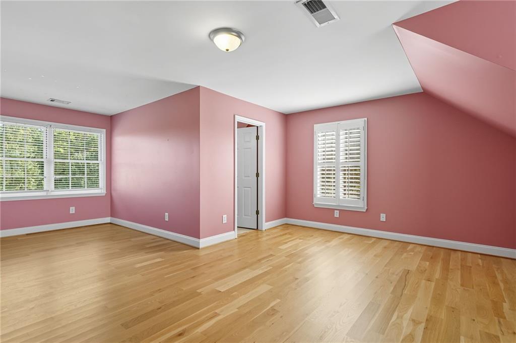 2347 Univeter Road Canton, GA 30115 - Photo 27 of 46 a view of an empty room with a window and wooden floor
