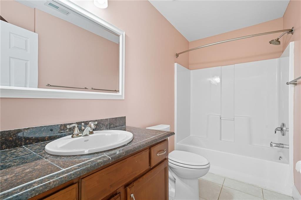 2347 Univeter Road Canton, GA 30115 - Photo 29 of 46 a bathroom with a sink a toilet and shower