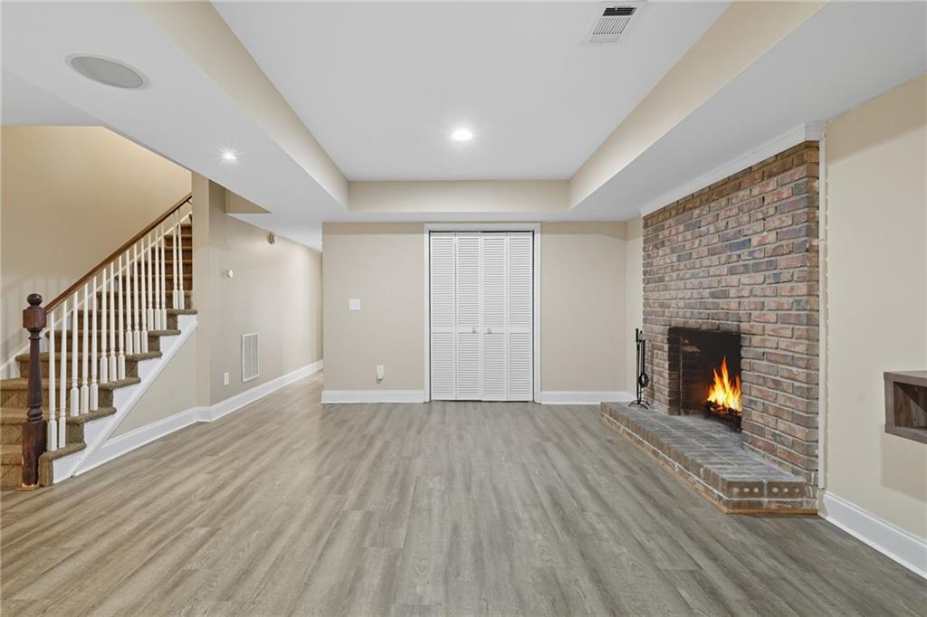 2347 Univeter Road Canton, GA 30115 - Photo 30 of 46 an empty room with wooden floor fireplace and windows