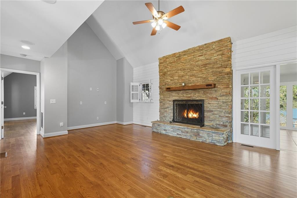 2347 Univeter Road Canton, GA 30115 - Photo 7 of 46 a view of empty room with wooden floor and fireplace