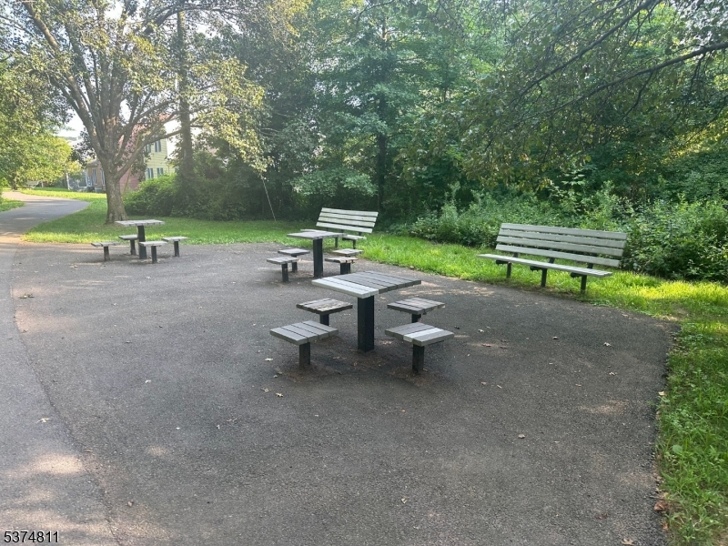 66 Mountain Court, Unit 66 Bedminster, NJ 07921 - Photo 15 of 18 a view of a park with large trees and wooden fence