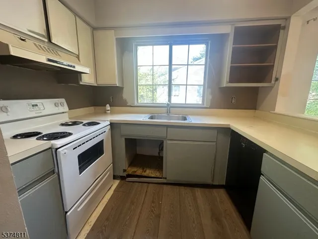 a kitchen with a sink stove and cabinets