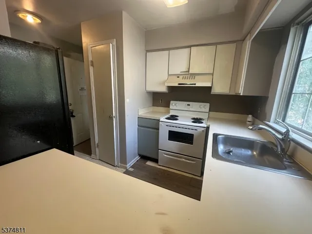 a kitchen with a stove and a refrigerator