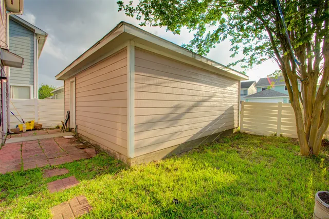 a view of a backyard with a large tree