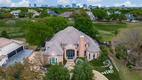 a front view of a house with a yard and lake view