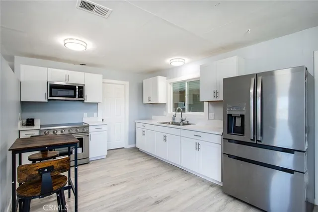 a kitchen with stainless steel appliances a refrigerator stove microwave and cabinets