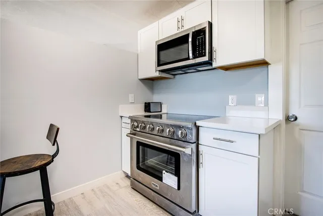a kitchen with a stove and a microwave