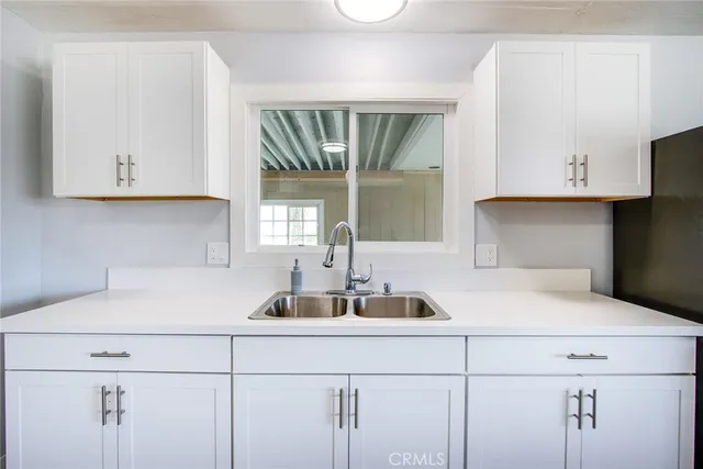 a kitchen with a sink and cabinets