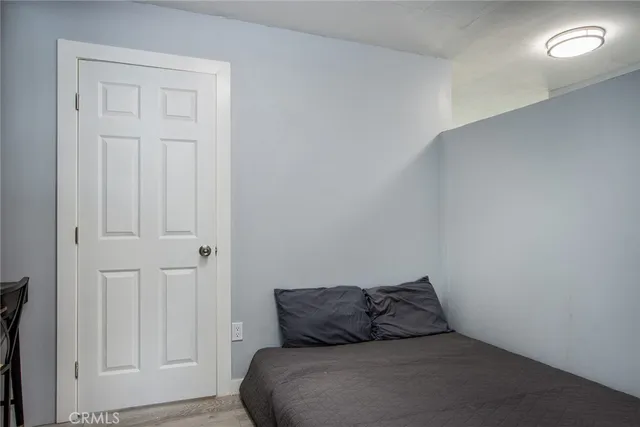 a bedroom with a bed and cabinets