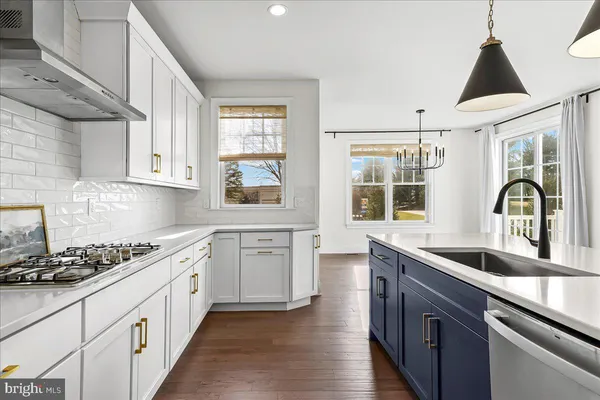 a kitchen that has a sink and a stove