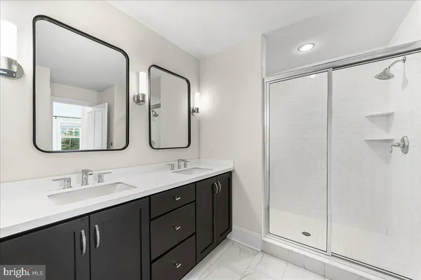 a bathroom with a double vanity sink mirror and double