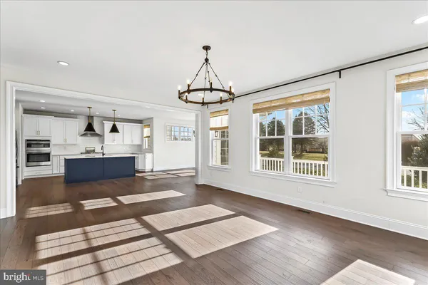a view of a living room with hardwood floor and a window