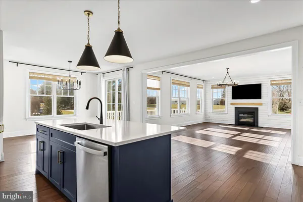 a kitchen with stainless steel appliances granite countertop a sink and a stove