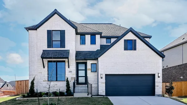 a front view of a house with garage