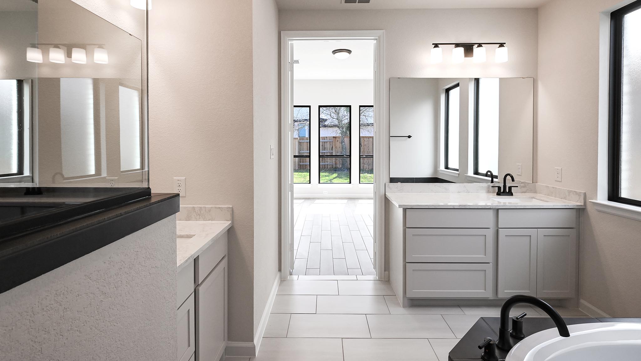 239 Prickly Poppy Loop Kyle, TX 78640 - Photo 19 of 26 a bathroom with a sink vanity and a mirror