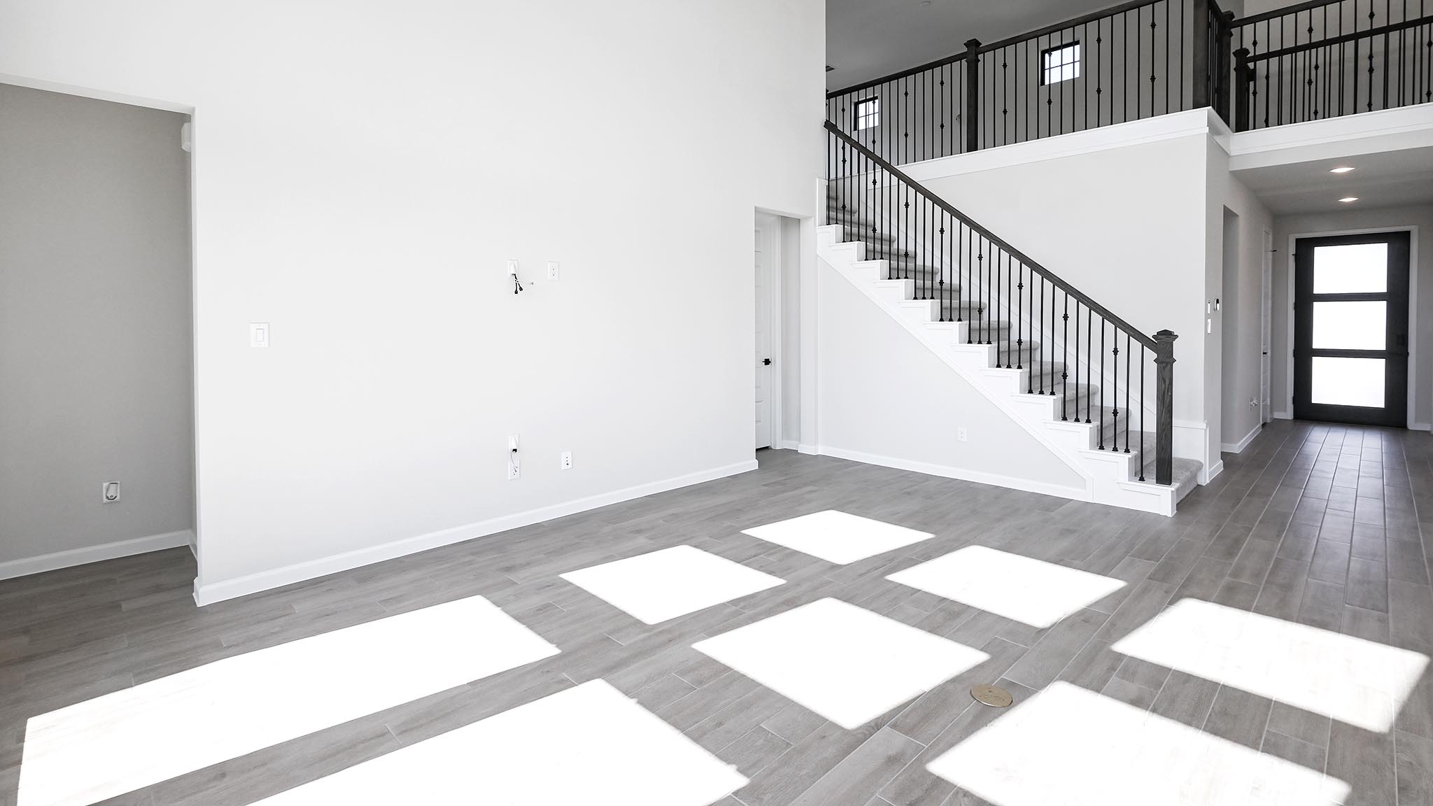 239 Prickly Poppy Loop Kyle, TX 78640 - Photo 20 of 26 a view of a hallway with wooden floor and stairs