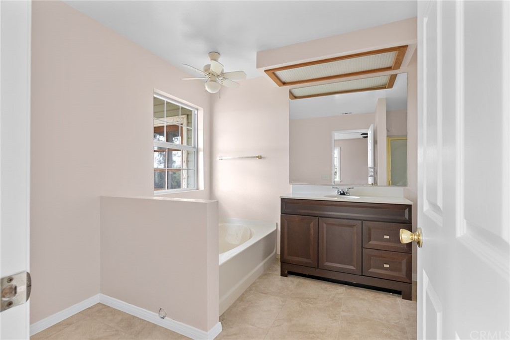 33796 Arthur Road Winchester, CA 92596 - Photo 17 of 54 a spacious bathroom with a double vanity sink a mirror and a bathtub