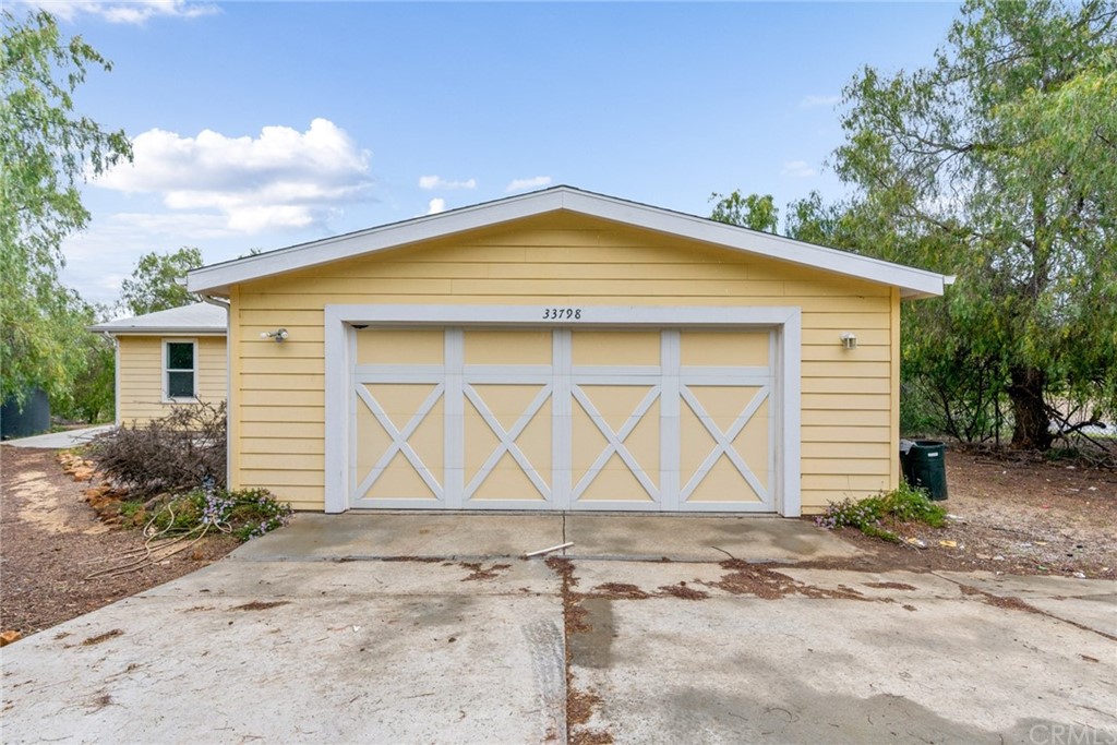 33796 Arthur Road Winchester, CA 92596 - Photo 34 of 54 a front view of a house with a yard and garage