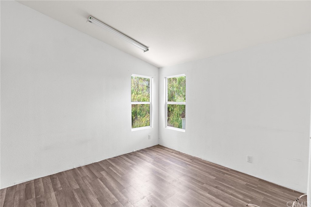 33796 Arthur Road Winchester, CA 92596 - Photo 36 of 54 an empty room with wooden floor and windows