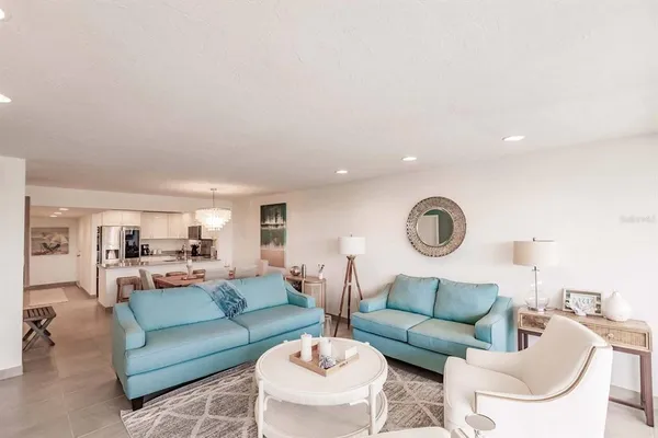 a living room with furniture a clock and a large window