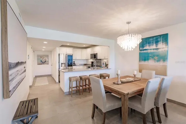 a view of a dining room with furniture and chandelier