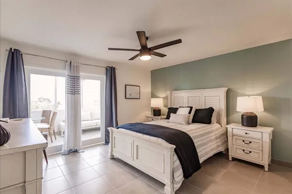 a bedroom with a bed and a large window