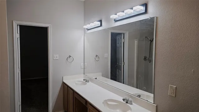 a bathroom with a sink vanity and mirror