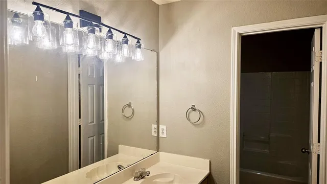 a bathroom with a shower and a sink