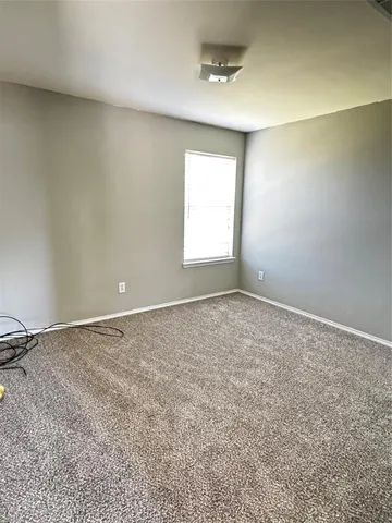 an empty room with a empty space and windows