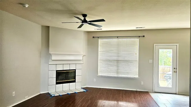 a view of a livingroom with a ceiling fan and window