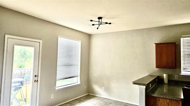 a view of a hallway with a window and a ceiling fan
