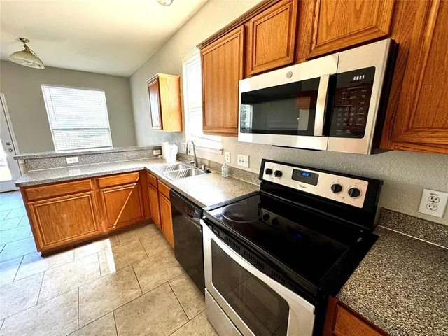 a kitchen with a stove sink and a microwave