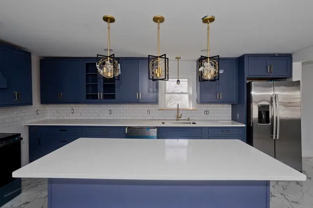 a kitchen with stainless steel appliances a sink and cabinets