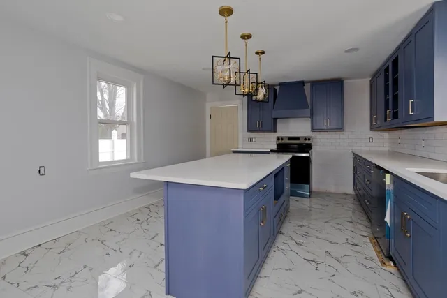 a kitchen with stainless steel appliances a sink stove and cabinets
