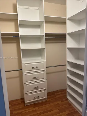 a view of walk in closet with empty racks