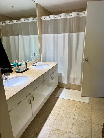 a bathroom with a double vanity sink and a mirror